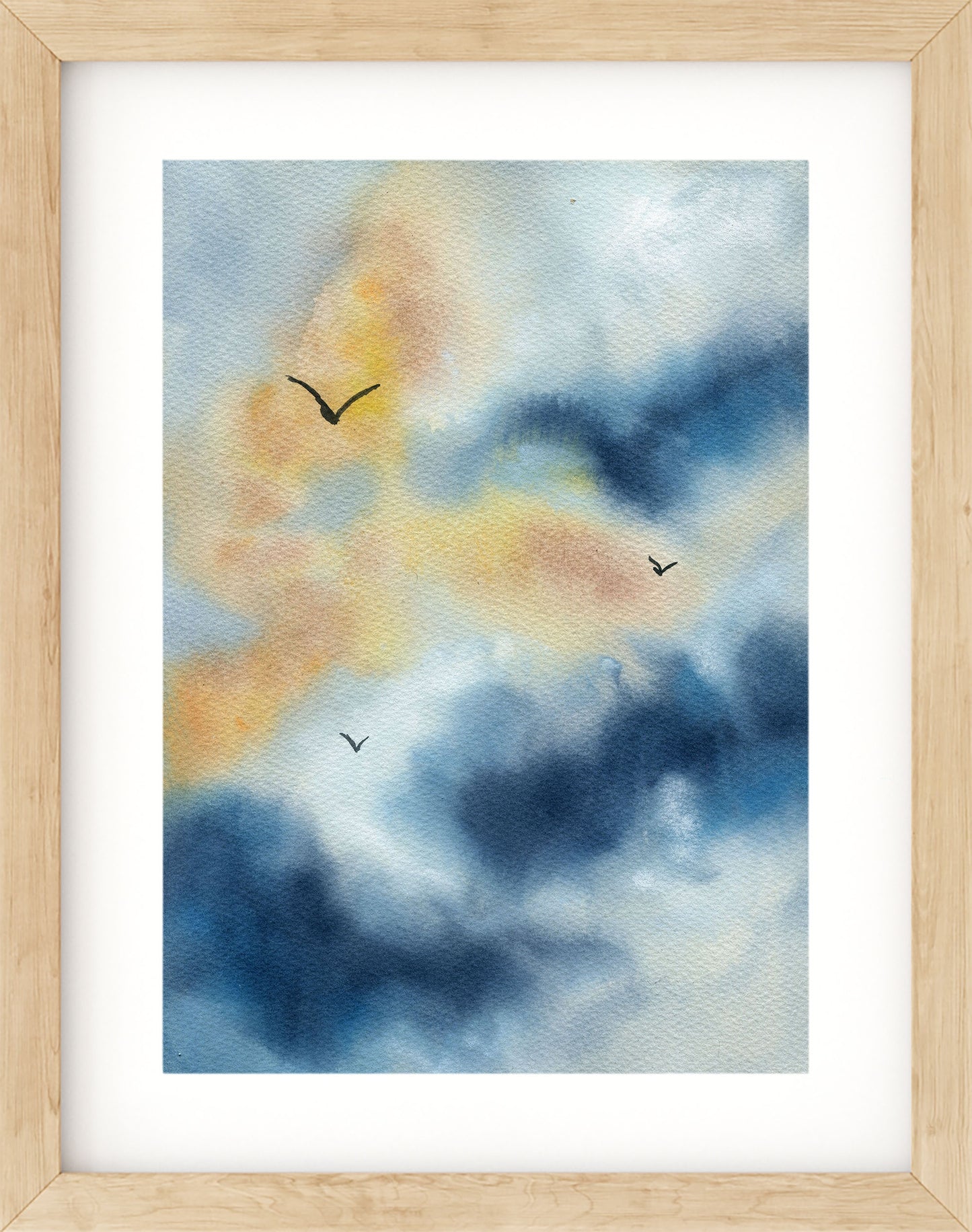 Framed artwork of a watercolor painting of birds flying against a blue and orange sky.
