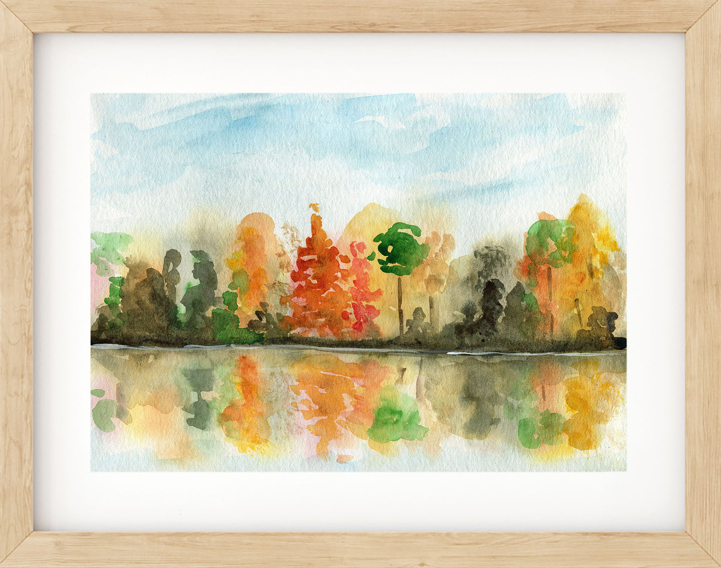 Framed watercolor painting of a forest with autumn colors reflected in a lake.