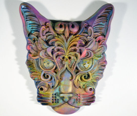 A hand-painted 3D wood carving of a cat with a vibrant, colorful design, finished with a wax topcoat and distressed for a decorative effect.