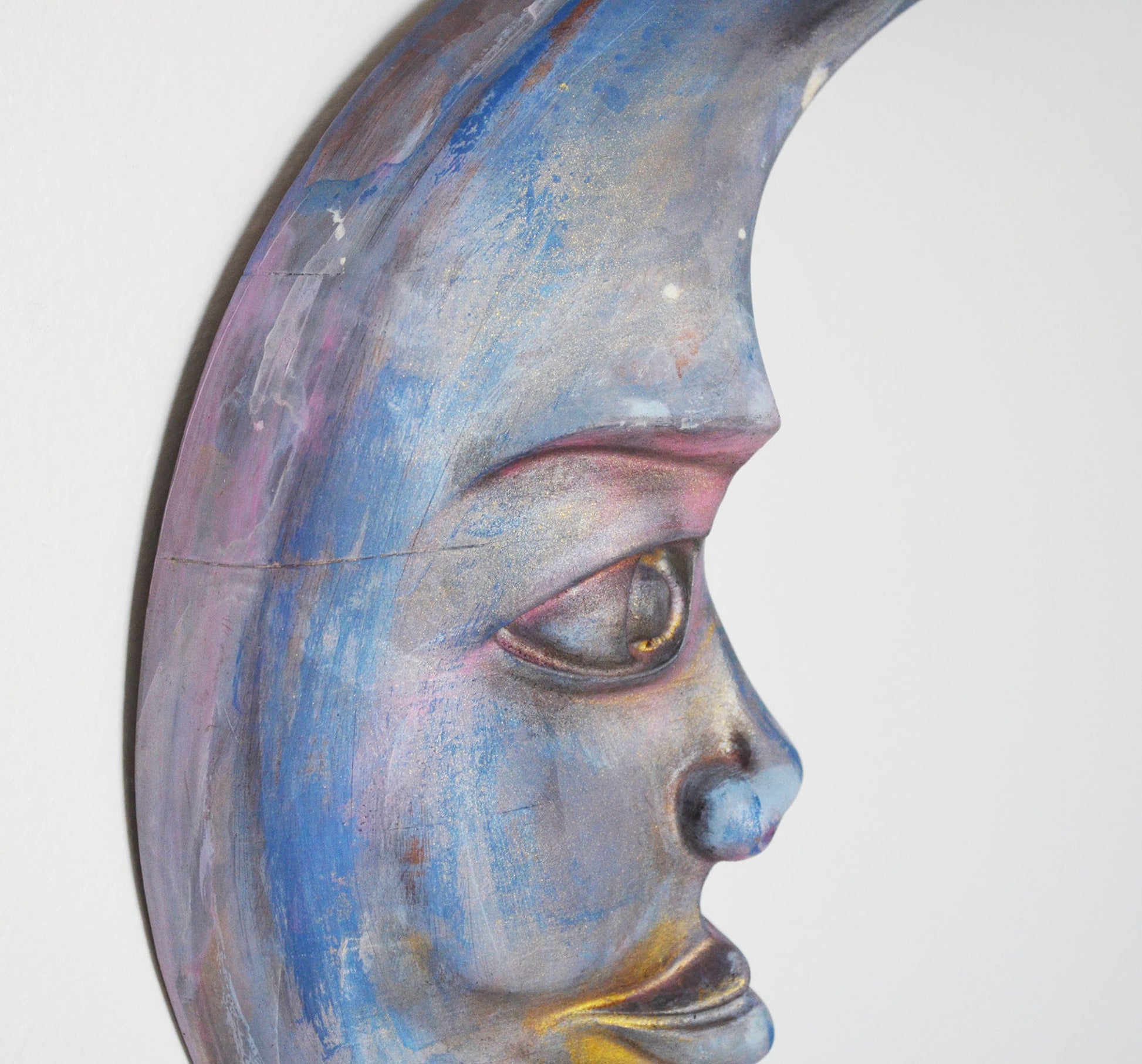 Close-up of a moon face with blue and gray tones on a white background