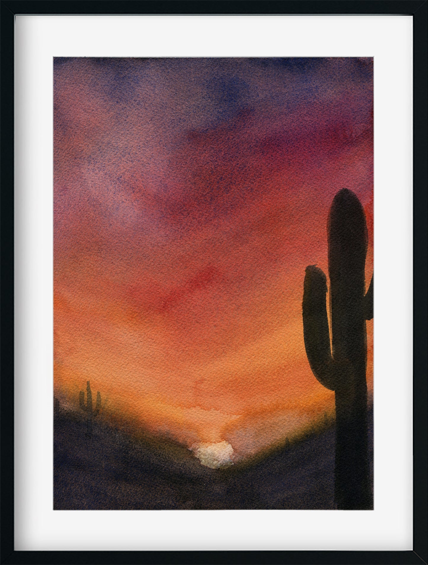 Framed artwork of a cactus against a sunset sky