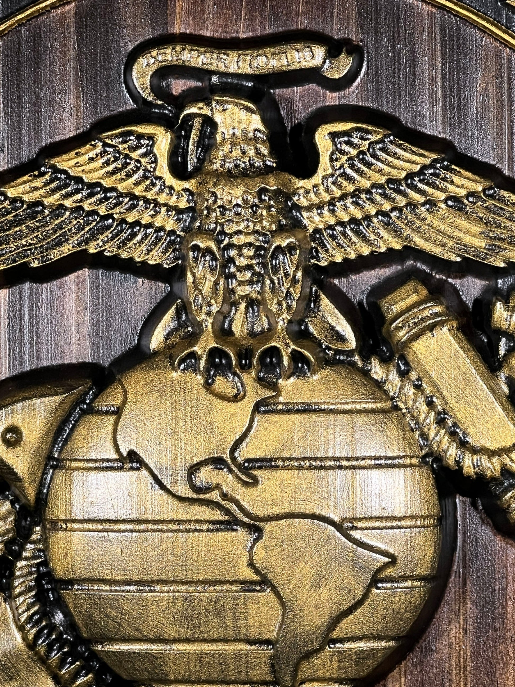 Bronze eagle emblem with globe on a wooden background