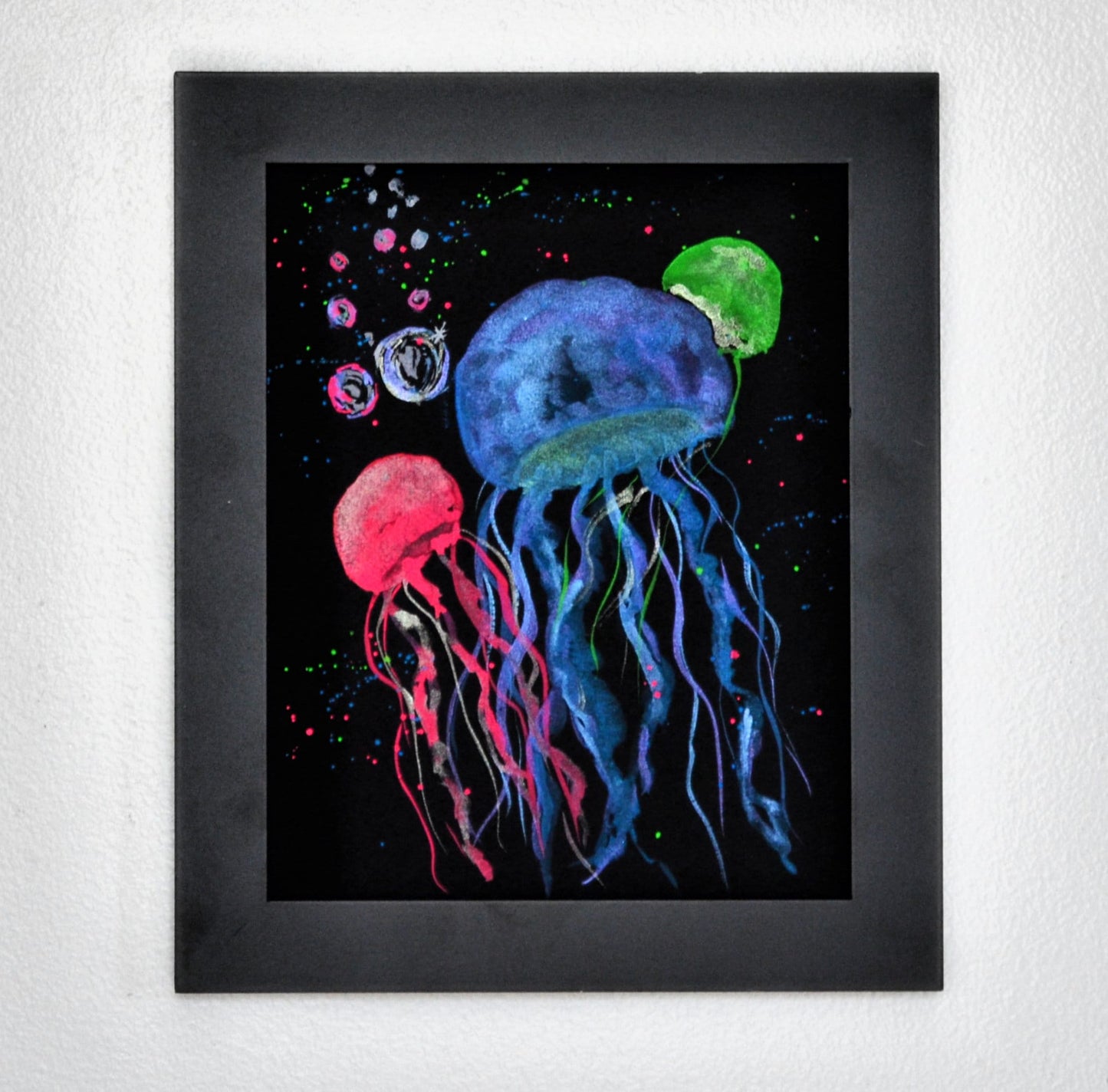 Metallic and neon watercolor jellyfish on black watercolor paper