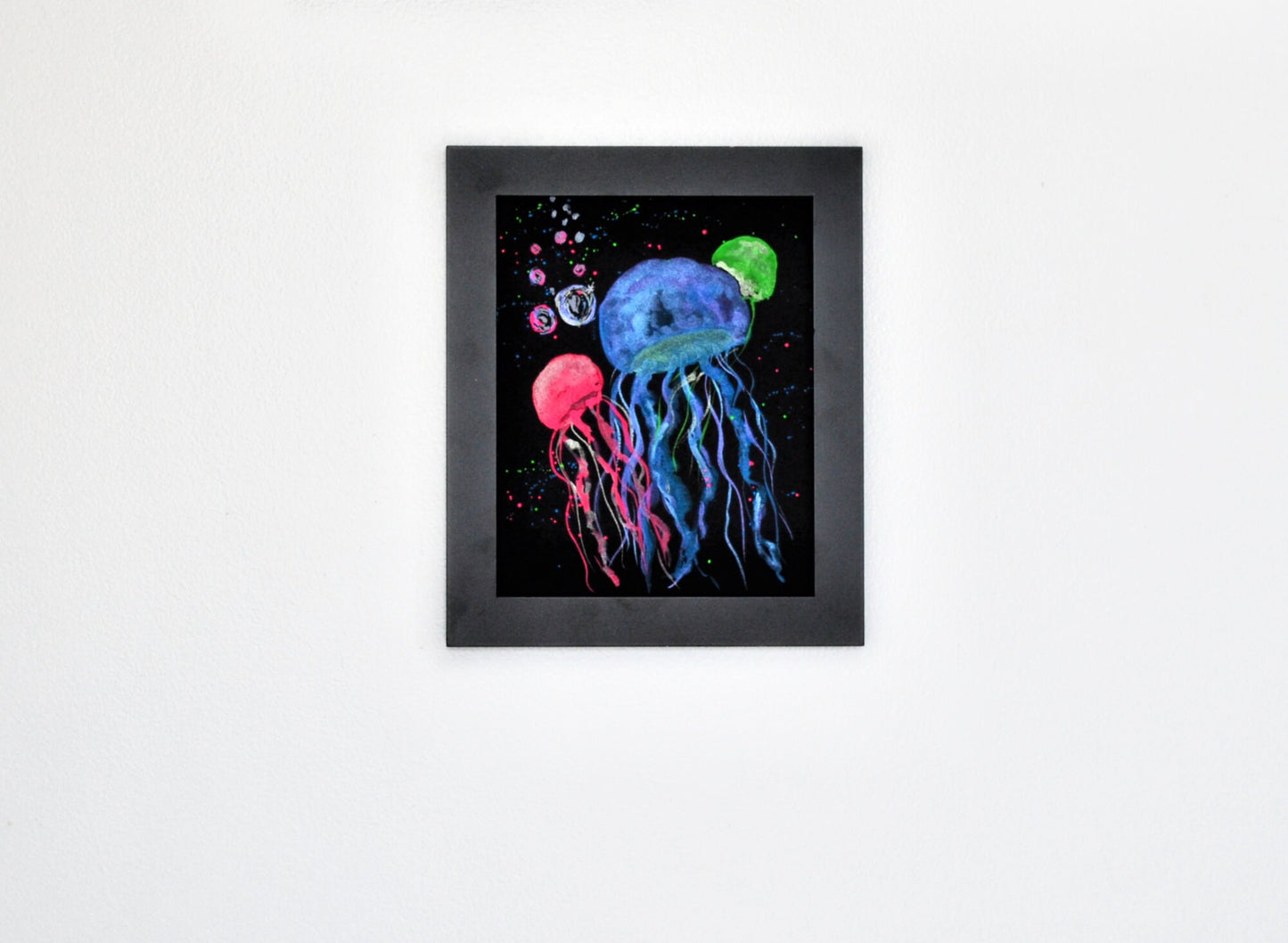 Metallic and neon watercolor jellyfish on black watercolor paper