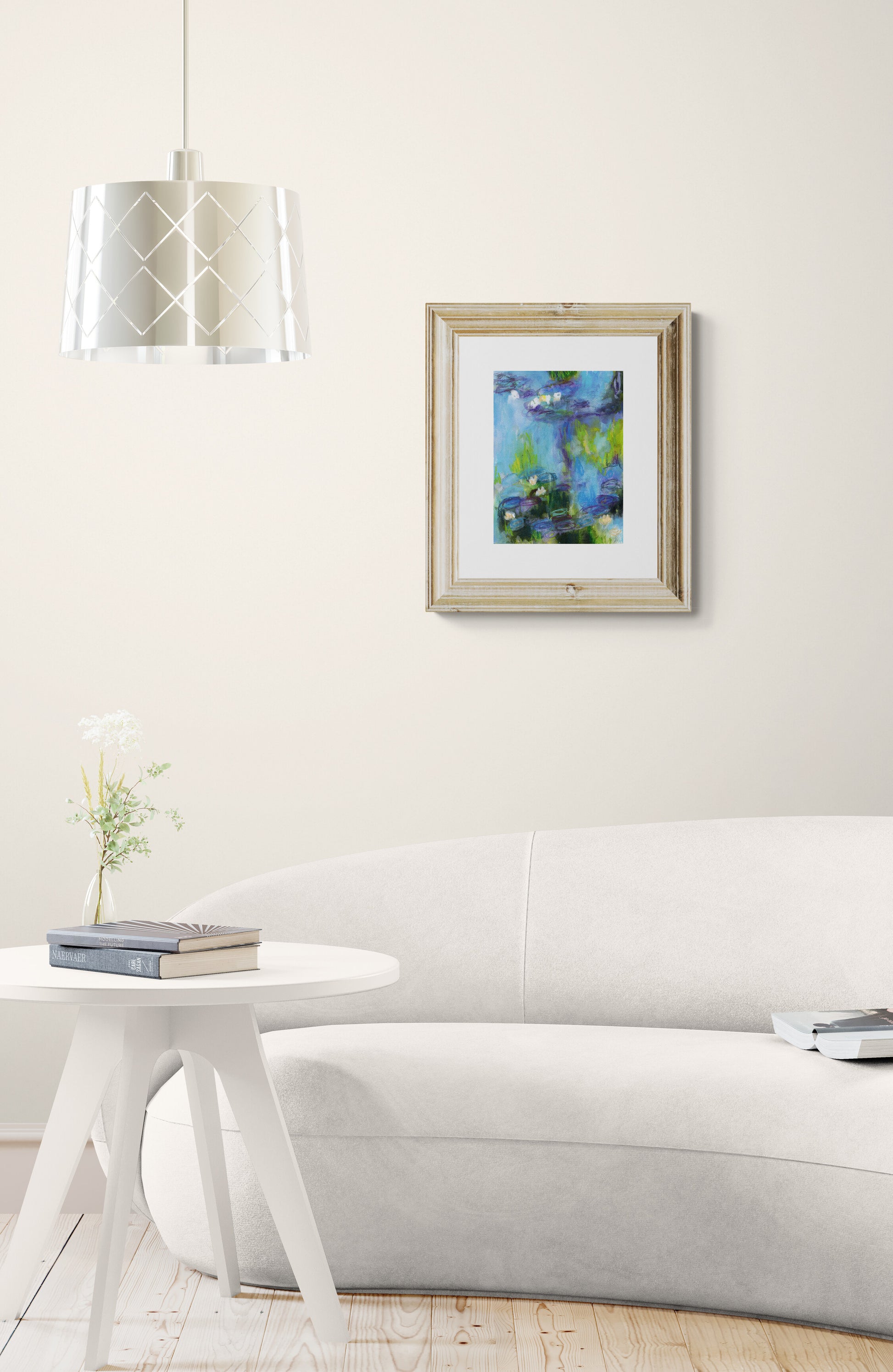 Framed artwork on a wall above a white sofa in a living room.