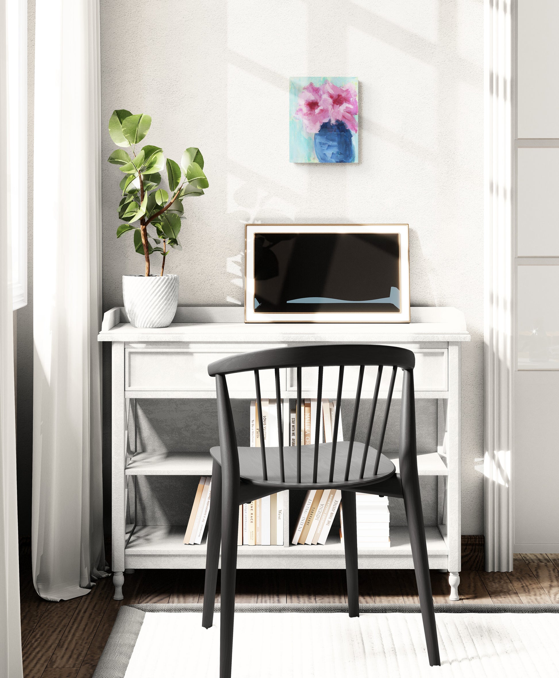 Small home office with a desk, chair, and decorative items.