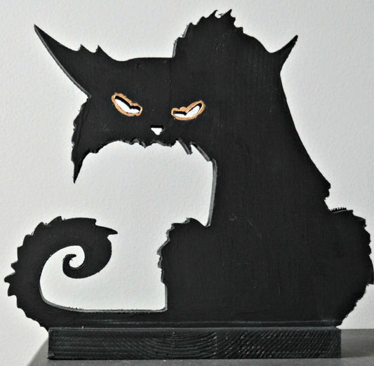 A 3D wood carving of a black cat with a spooky expression, featuring a dark body and orange eyes, intended for Halloween decoration.