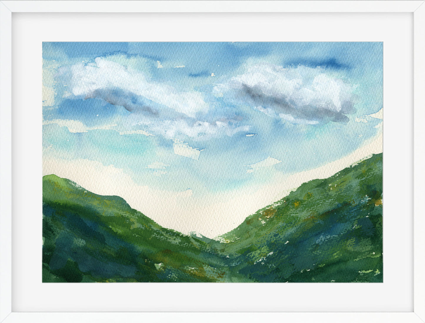 Framed watercolor painting of green hills and a blue sky with clouds.