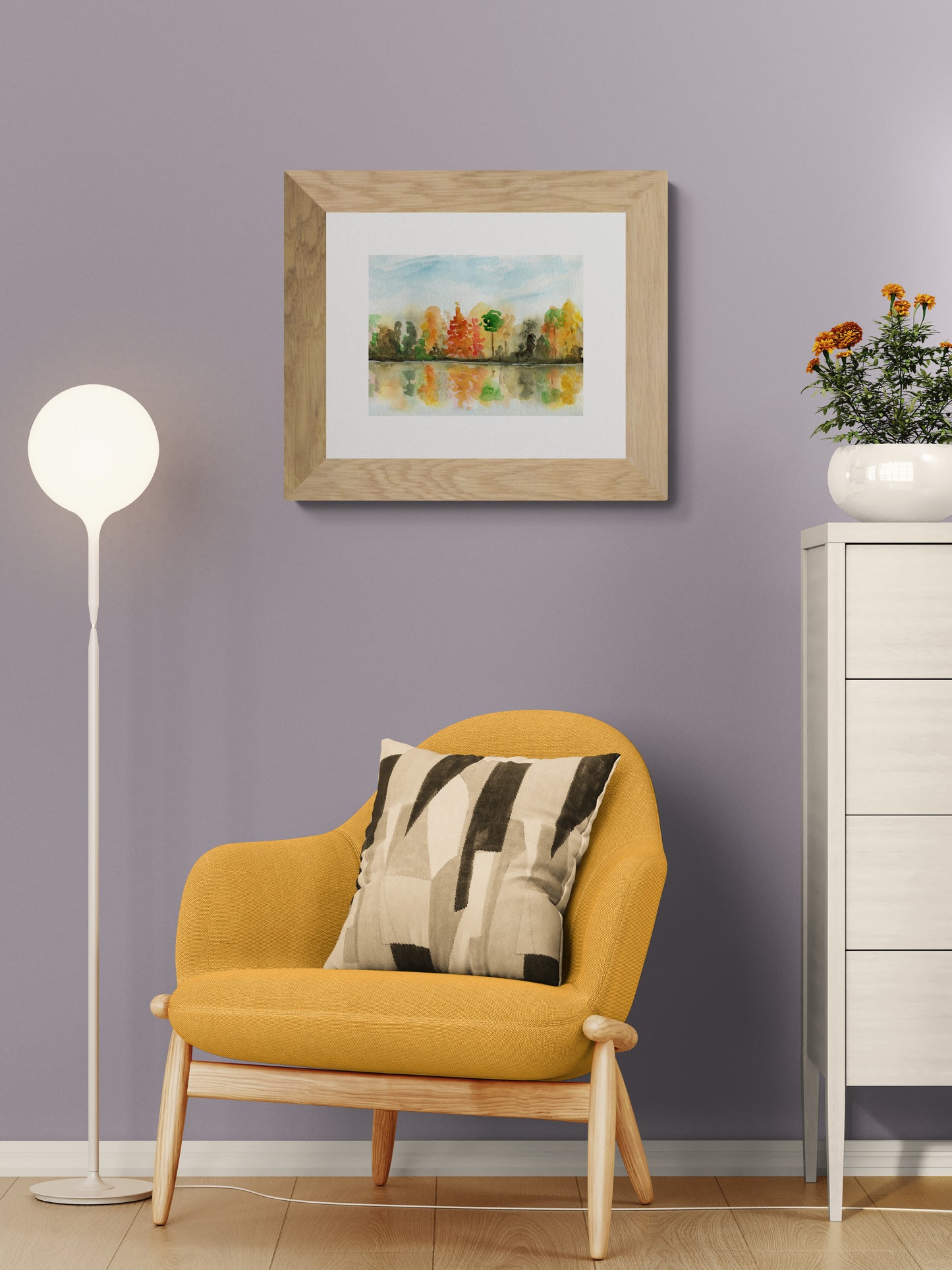 Yellow armchair with a decorative pillow in a room with a framed painting on the wall.