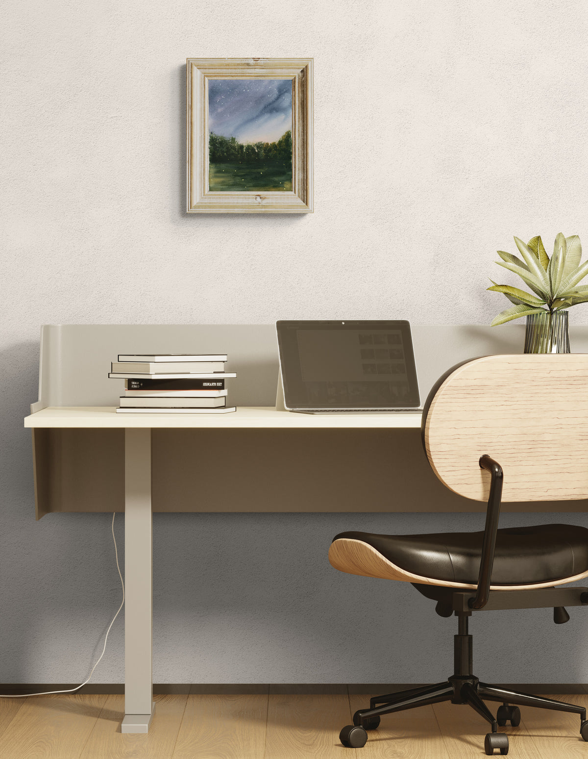 A modern home office setup featuring a white floating desk with a light gray panel, styled with a laptop, books, and a small plant. In front of the desk is a contemporary office chair with a light wood backrest, black leather seat, and black metal frame.