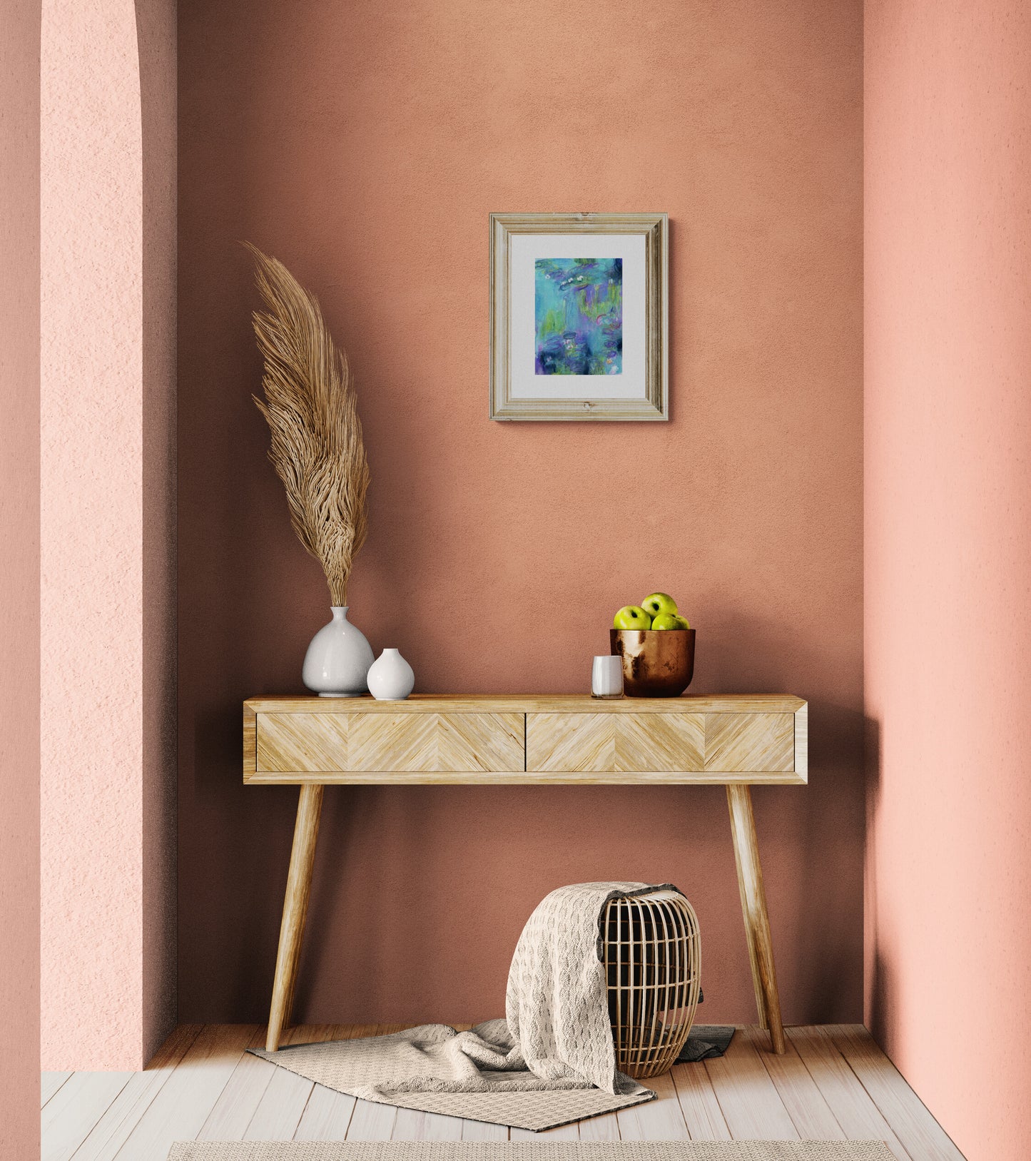 Wooden console table against a pink wall with decorative items.
