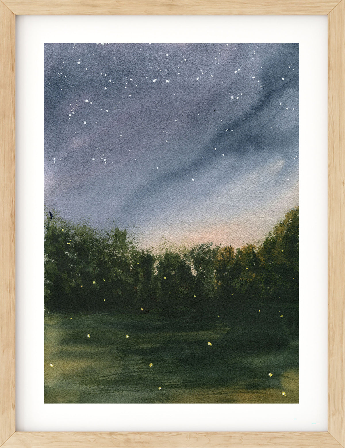 A framed watercolor painting of a starry night sky over a dark forest with glowing firefly-like lights, presented in a light wood frame with a white mat.