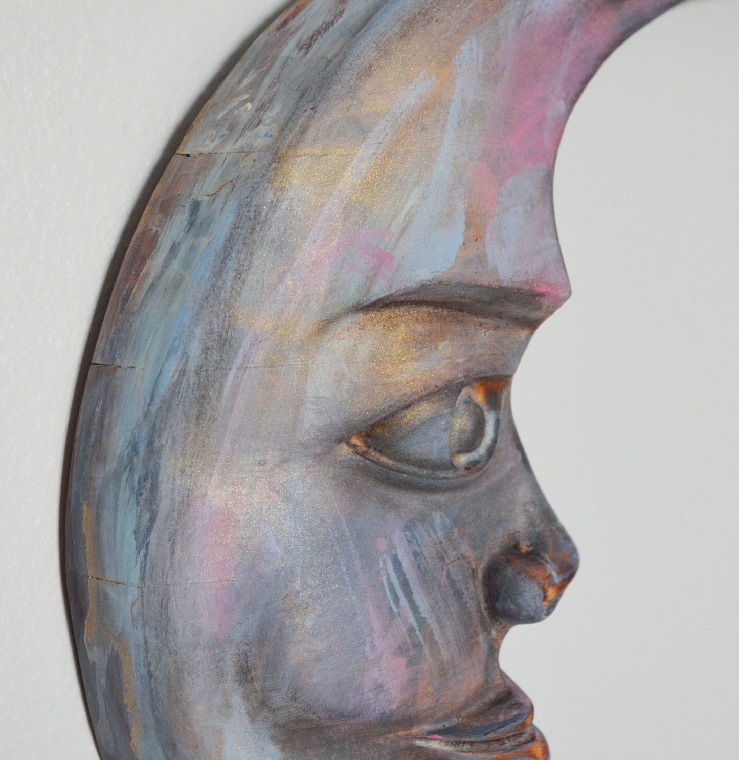 Abstract art piece of a face with multicolored paint on a white background