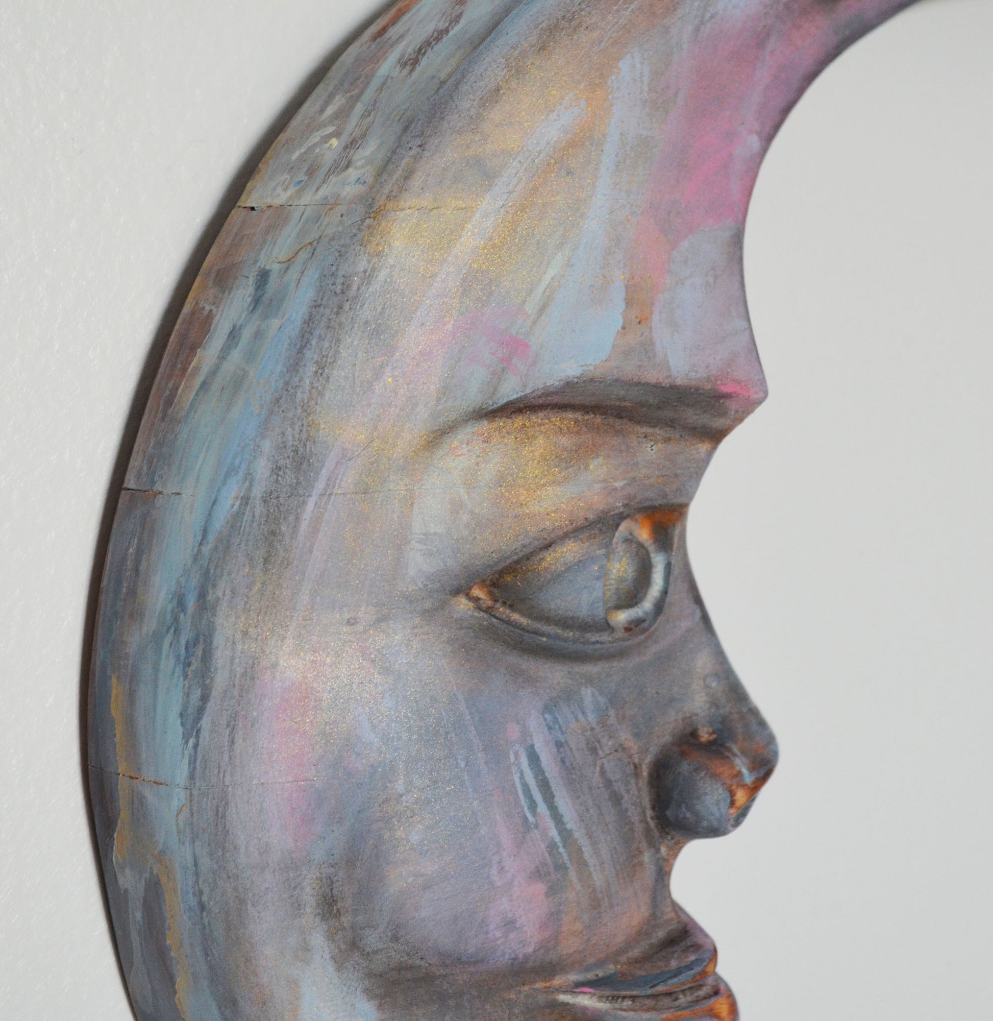 Abstract art piece of a face with multicolored paint on a white background